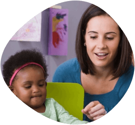 young child and teacher in classroom