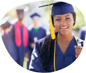 young woman wearing graduation gown and cap, holding a rolled up diploma